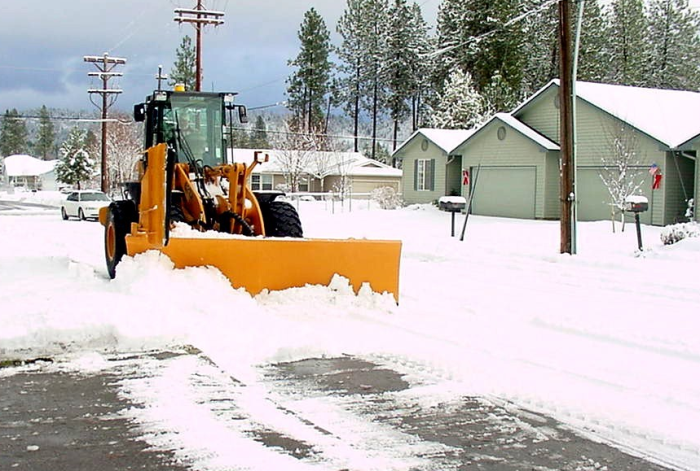 Tractor plowing snow.